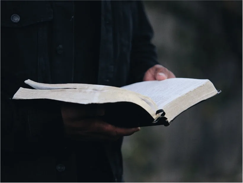 Men gathered around an open Bible